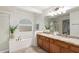 Bright bathroom features a shower, soaking tub and dual sink vanity with granite countertop at 25425 N 64Th Ave, Phoenix, AZ 85083