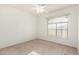 A bright bedroom with neutral carpet and a large window at 25425 N 64Th Ave, Phoenix, AZ 85083