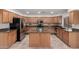 Kitchen boasts an island with granite countertop and stainless steel appliances at 25425 N 64Th Ave, Phoenix, AZ 85083