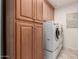 Laundry room with wood cabinets and appliances at 25425 N 64Th Ave, Phoenix, AZ 85083