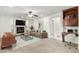 Inviting living room with a fireplace, comfortable seating, and a dedicated workspace, creating a versatile and stylish atmosphere at 25425 N 64Th Ave, Phoenix, AZ 85083