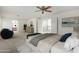 Spacious main bedroom with natural light, a seating area, and a glimpse into the luxurious ensuite bathroom at 25425 N 64Th Ave, Phoenix, AZ 85083