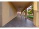 A covered outdoor patio with tile flooring, and ceiling fan overlooking the yard at 25425 N 64Th Ave, Phoenix, AZ 85083