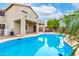 Backyard pool view with covered patio and desert landscaping at 25695 W Crown King Rd, Buckeye, AZ 85326