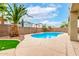 Sparkling pool with surrounding desert plants and a covered patio at 25695 W Crown King Rd, Buckeye, AZ 85326