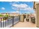 Relaxing balcony features outdoor seating, iron railing, and neighborhood views at 25695 W Crown King Rd, Buckeye, AZ 85326
