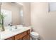 Powder room featuring a stylish mirror, vanity, and toilet at 25695 W Crown King Rd, Buckeye, AZ 85326