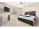 Cozy bedroom features a bed with a ceiling fan at 25695 W Crown King Rd, Buckeye, AZ 85326
