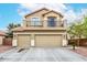 Inviting two-story home featuring a balcony above the three-car garage and low maintenance landscaping at 25695 W Crown King Rd, Buckeye, AZ 85326
