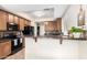 Well-equipped kitchen featuring granite countertops, wood cabinets, a microwave, and electric range at 25695 W Crown King Rd, Buckeye, AZ 85326