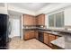 Kitchen with stainless steel appliances, wood cabinets, mosaic backsplash and tiled floors at 25695 W Crown King Rd, Buckeye, AZ 85326