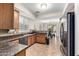 Inviting kitchen boasts sleek appliances, granite countertops, and seamless access to the adjacent dining area at 25695 W Crown King Rd, Buckeye, AZ 85326