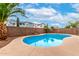 Inviting pool with desert landscaping and brick perimeter at 25695 W Crown King Rd, Buckeye, AZ 85326