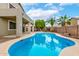 Gorgeous pool with covered patio in a private backyard with palms and desert landscaping at 25695 W Crown King Rd, Buckeye, AZ 85326