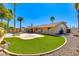 Beautiful backyard with green grass, pool, patio, and charming landscaping at 302 E Carol Ann Way, Phoenix, AZ 85022