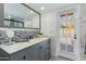 Bathroom with a vanity, decorated mirror and a view to the exterior at 302 E Carol Ann Way, Phoenix, AZ 85022