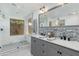 Modern bathroom featuring double sinks, mosaic tile accents, and a walk-in shower at 302 E Carol Ann Way, Phoenix, AZ 85022