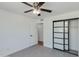 Bedroom with a ceiling fan, tile floor, and sliding mirrored closet doors at 302 E Carol Ann Way, Phoenix, AZ 85022