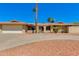 Charming single-story home with a well-maintained yard, mature trees, and a two-car garage at 302 E Carol Ann Way, Phoenix, AZ 85022