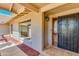 Inviting entryway with a security door, decorative window, and tiled porch at 302 E Carol Ann Way, Phoenix, AZ 85022