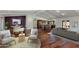 Open-concept living room with wood floors, beamed ceilings, and stylish furnishings at 302 E Carol Ann Way, Phoenix, AZ 85022