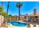 Lush backyard featuring a sparkling pool, covered patio, and mature landscaping at 302 E Carol Ann Way, Phoenix, AZ 85022