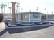 Inviting single-story home showcasing tasteful desert landscaping and a covered carport at 303 S Recker Rd # 62, Mesa, AZ 85206