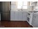 Modern kitchen with stainless steel appliances, sleek gray cabinets, and a bright window at 303 S Recker Rd # 62, Mesa, AZ 85206