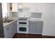 This kitchen features stainless steel appliances, white cabinetry and a subway tile backsplash at 303 S Recker Rd # 62, Mesa, AZ 85206