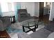 Spacious living room with a modern rug, glass table, and comfortable recliner seating at 303 S Recker Rd # 62, Mesa, AZ 85206