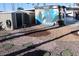 The backyard features artistic stone landscaping and a charming garden shed with custom art at 303 S Recker Rd # 62, Mesa, AZ 85206