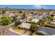 Aerial view of a home on a tree-lined street with desert landscaping, located near shopping at 4249 E Mitchell Dr, Phoenix, AZ 85018
