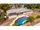 A backyard pool with a large patio and green grass near the home at 4249 E Mitchell Dr, Phoenix, AZ 85018