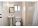 Cozy bathroom with pedestal sink, toilet, and shower over tub at 4249 E Mitchell Dr, Phoenix, AZ 85018
