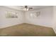 Bright bedroom featuring plush carpeting and two large windows at 4249 E Mitchell Dr, Phoenix, AZ 85018