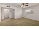 Bedroom featuring plush carpets, ceiling fan, and closet at 4249 E Mitchell Dr, Phoenix, AZ 85018