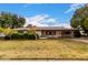 Charming single-story home featuring mature landscaping and a covered carport with a brick-accented facade at 4249 E Mitchell Dr, Phoenix, AZ 85018