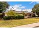 Charming single-story home featuring mature landscaping and a covered carport with a brick-accented facade at 4249 E Mitchell Dr, Phoenix, AZ 85018