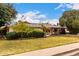 Charming single-story home featuring mature landscaping and a covered carport with a brick-accented facade at 4249 E Mitchell Dr, Phoenix, AZ 85018