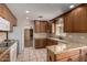 Well-lit kitchen features granite countertops, tile flooring, and plenty of cabinet space at 4249 E Mitchell Dr, Phoenix, AZ 85018