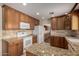 Bright kitchen features granite counters, tile backsplash, and white appliances at 4249 E Mitchell Dr, Phoenix, AZ 85018