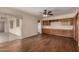 Bright living room boasts hardwood floors, built-in cabinets, and sliding glass door to patio at 4249 E Mitchell Dr, Phoenix, AZ 85018