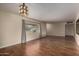 Bright living room features hardwood floors, neutral paint, decorative lighting, and a bright window at 4249 E Mitchell Dr, Phoenix, AZ 85018