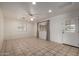 Bright living room featuring tile floors, a ceiling fan, and a large window at 4249 E Mitchell Dr, Phoenix, AZ 85018