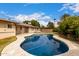 Lovely backyard pool and patio area with mature landscaping, a privacy fence and an exterior building at 4249 E Mitchell Dr, Phoenix, AZ 85018