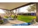 Relaxing covered back patio with an outdoor seating area overlooking a well-maintained yard at 4945 E Shapinsay Dr, San Tan Valley, AZ 85140