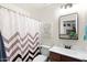 Modern bathroom with zig-zag shower curtain, contemporary mirror and vanity with a white sink at 4945 E Shapinsay Dr, San Tan Valley, AZ 85140
