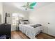 A cozy bedroom with modern ceiling fan, plush rug and hardwood flooring at 4945 E Shapinsay Dr, San Tan Valley, AZ 85140