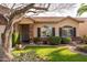 Inviting front entrance with a brick pillar, arched windows, and a green manicured lawn at 4945 E Shapinsay Dr, San Tan Valley, AZ 85140