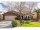 Charming single-story home with brick accents, lush lawn and a well-manicured yard at 4945 E Shapinsay Dr, San Tan Valley, AZ 85140